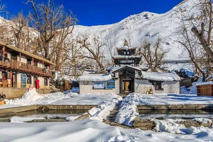 Muktinath Temple in Mustang, Nepal, surrounded by serene landscape and pilgrims.